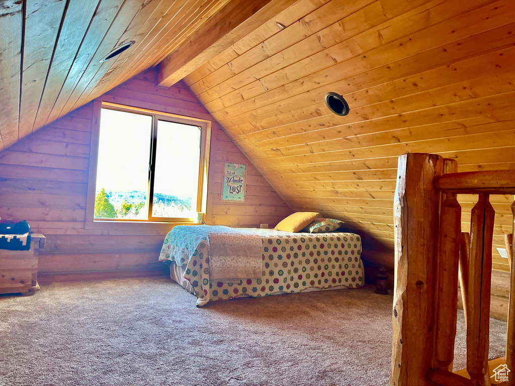 Carpeted bedroom featuring wooden ceiling, vaulted ceiling with beams, and rustic walls