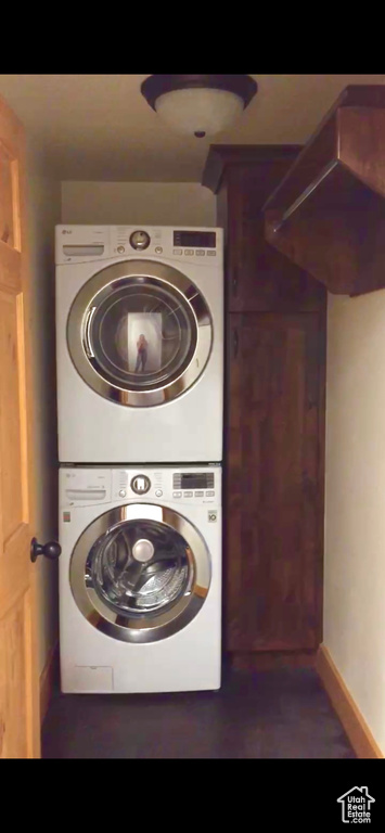 Washroom featuring stacked washer / drying machine