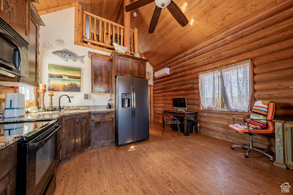 Kitchen featuring hardwood / wood-style floors, log walls, stainless steel appliances, and wood ceiling