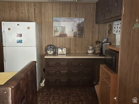 Kitchen featuring wood walls