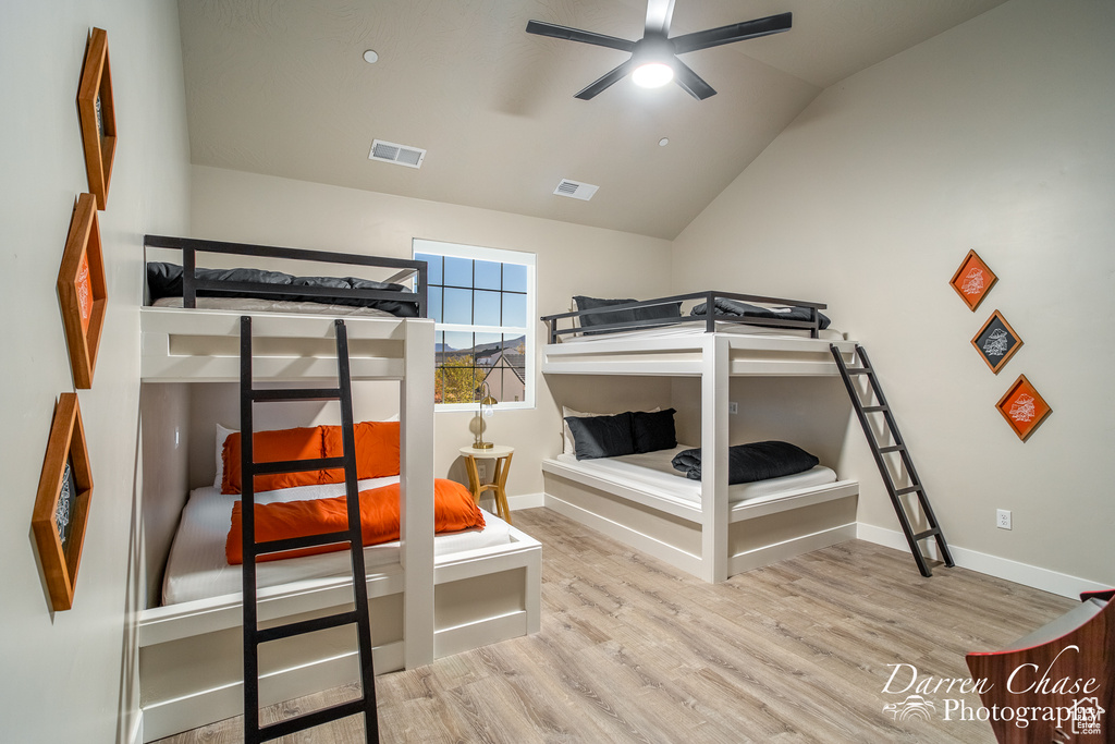 Bedroom with lofted ceiling and light hardwood / wood-style floors