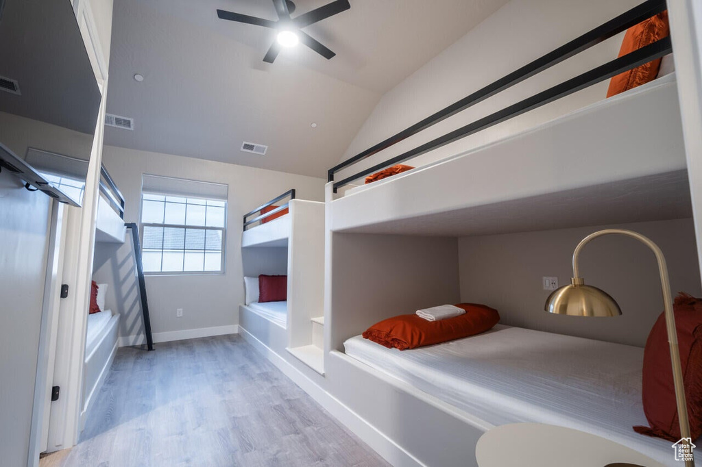 Bedroom featuring lofted ceiling, ceiling fan, and light hardwood / wood-style flooring