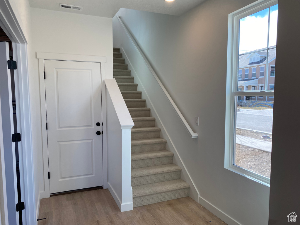 Stairway featuring light hardwood / wood-style floors