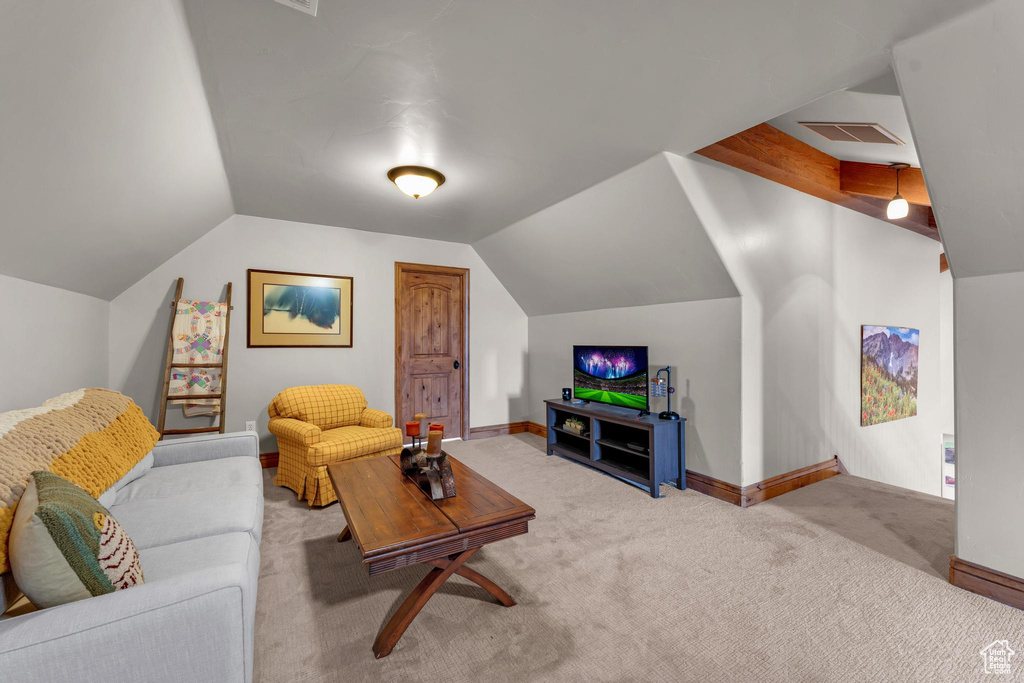 Living room featuring light carpet and vaulted ceiling