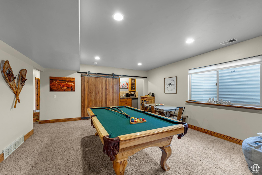 Rec room featuring light carpet, a barn door, and billiards