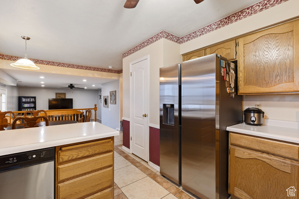 Kitchen with pendant lighting, stainless steel appliances, ceiling fan, and light tile floors