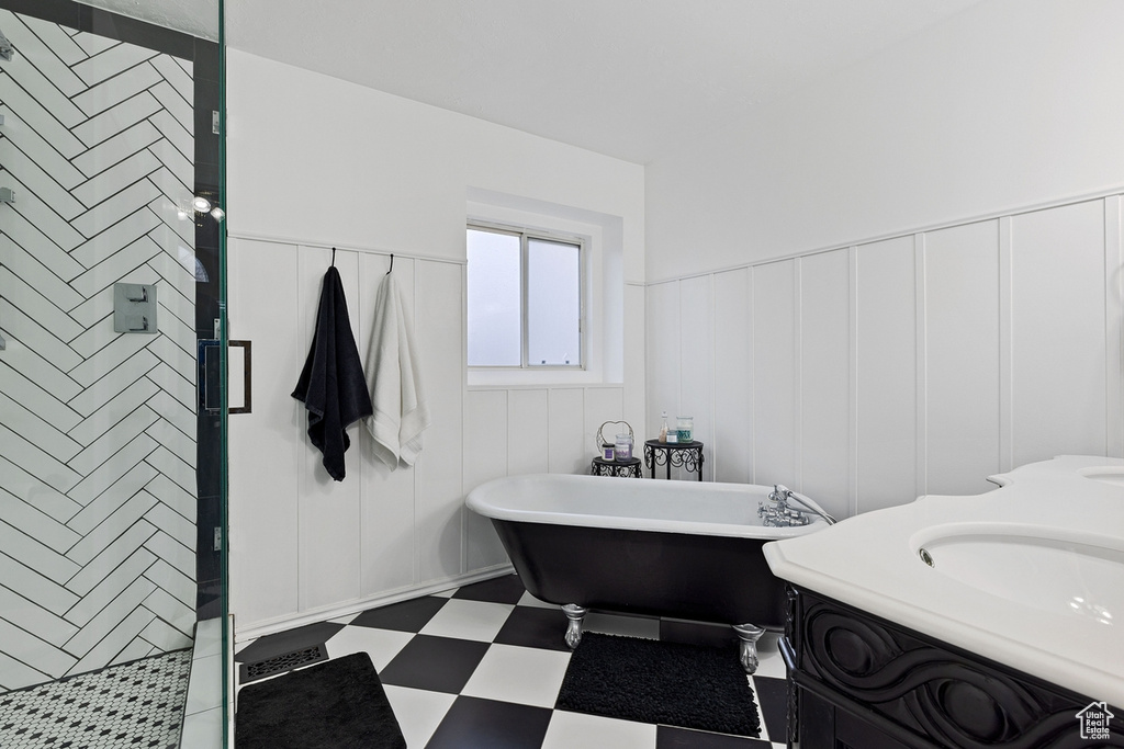 Bathroom featuring plus walk in shower, tile floors, and vanity