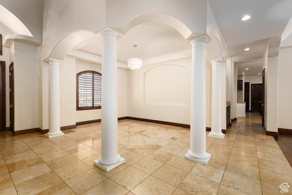 Interior space with light tile floors and ornate columns
