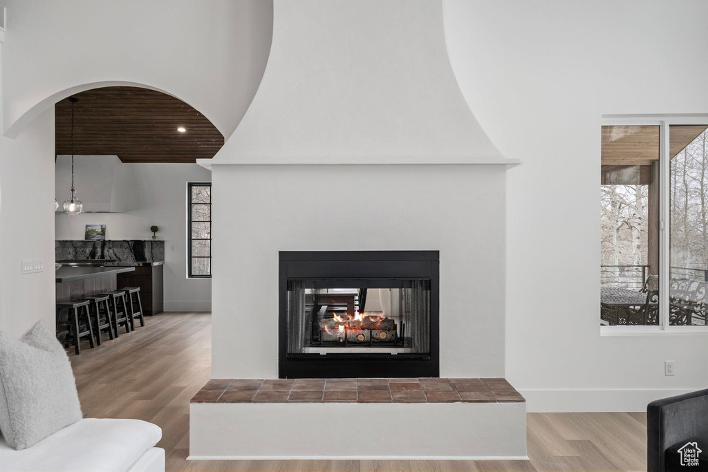 Room details featuring light wood-type flooring and a tiled fireplace