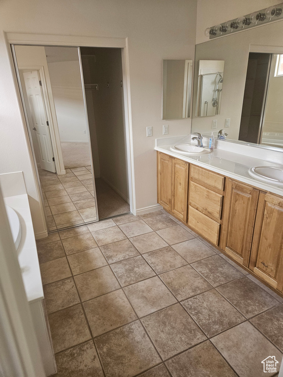Bathroom with tile flooring and dual vanity