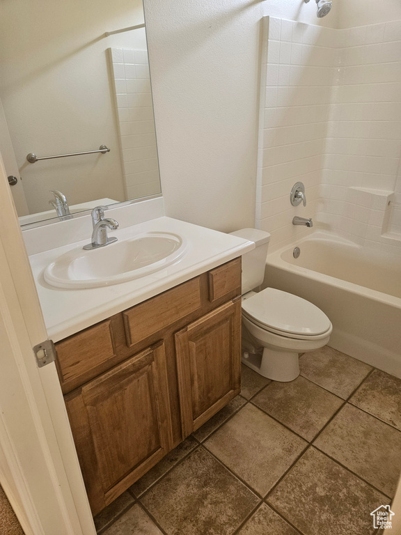 Full bathroom featuring shower / washtub combination, toilet, tile floors, and vanity