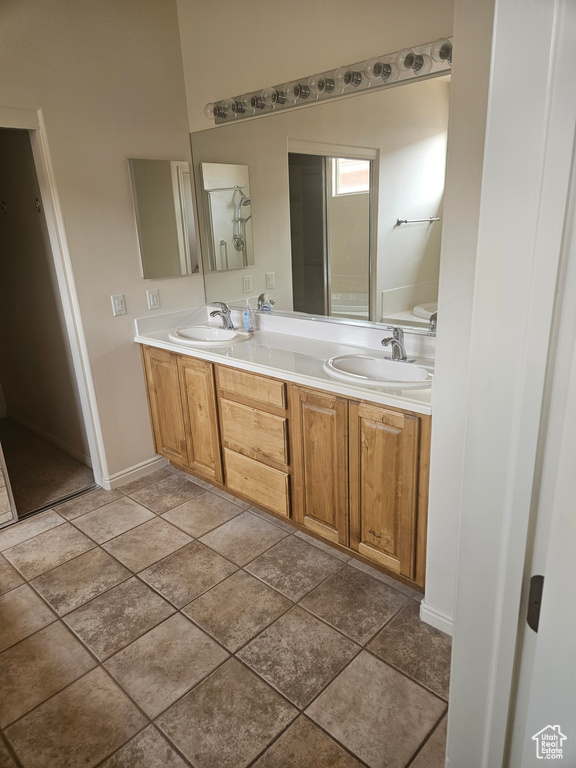 Bathroom featuring double vanity and tile floors