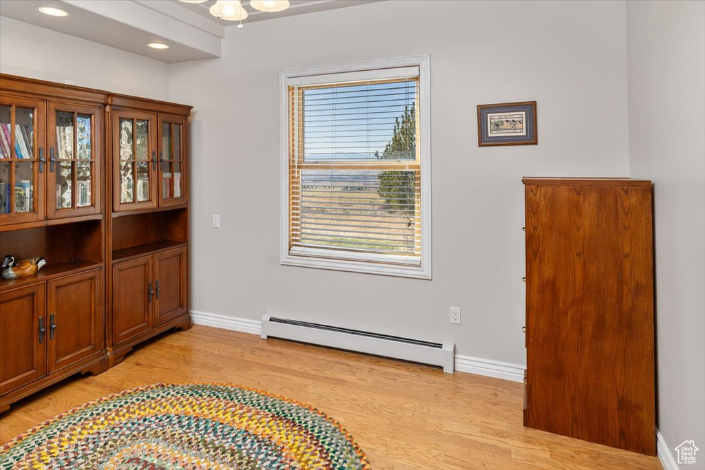 Sitting room featuring light hardwood / wood-style floors and a baseboard heating unit