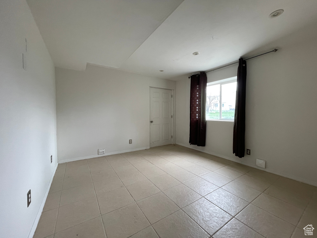 Spare room with light tile flooring