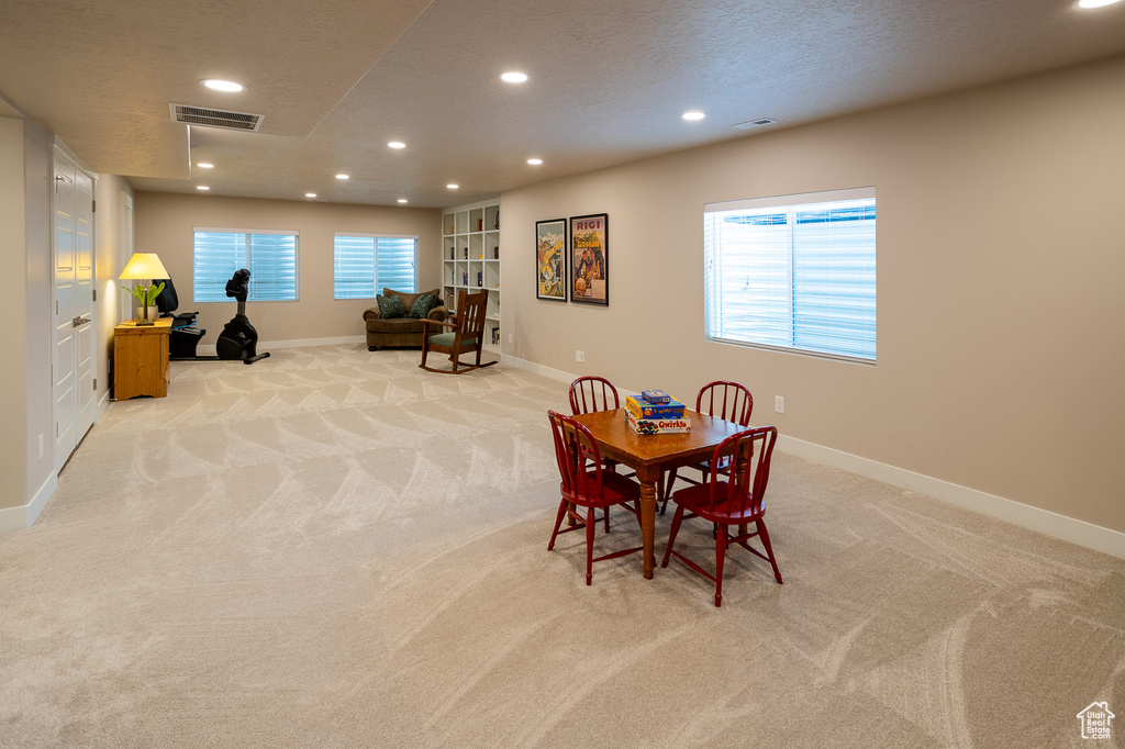 Game room featuring a textured ceiling and light colored carpet