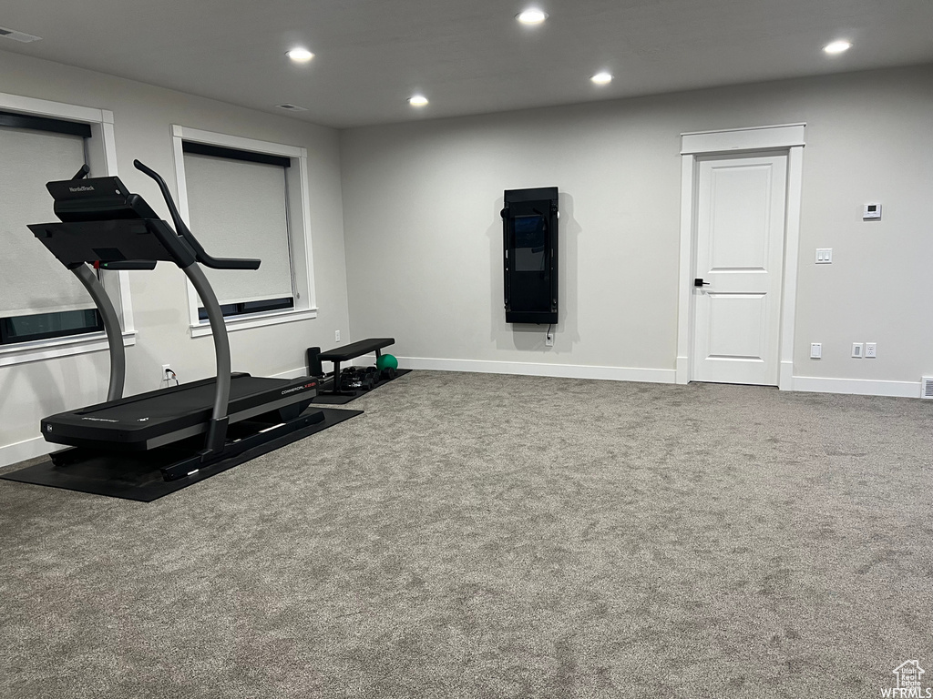 Workout room featuring dark colored carpet