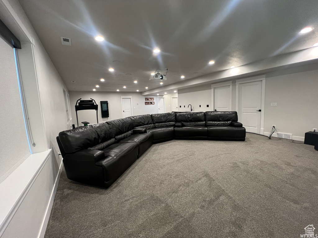 Home theater with dark colored carpet