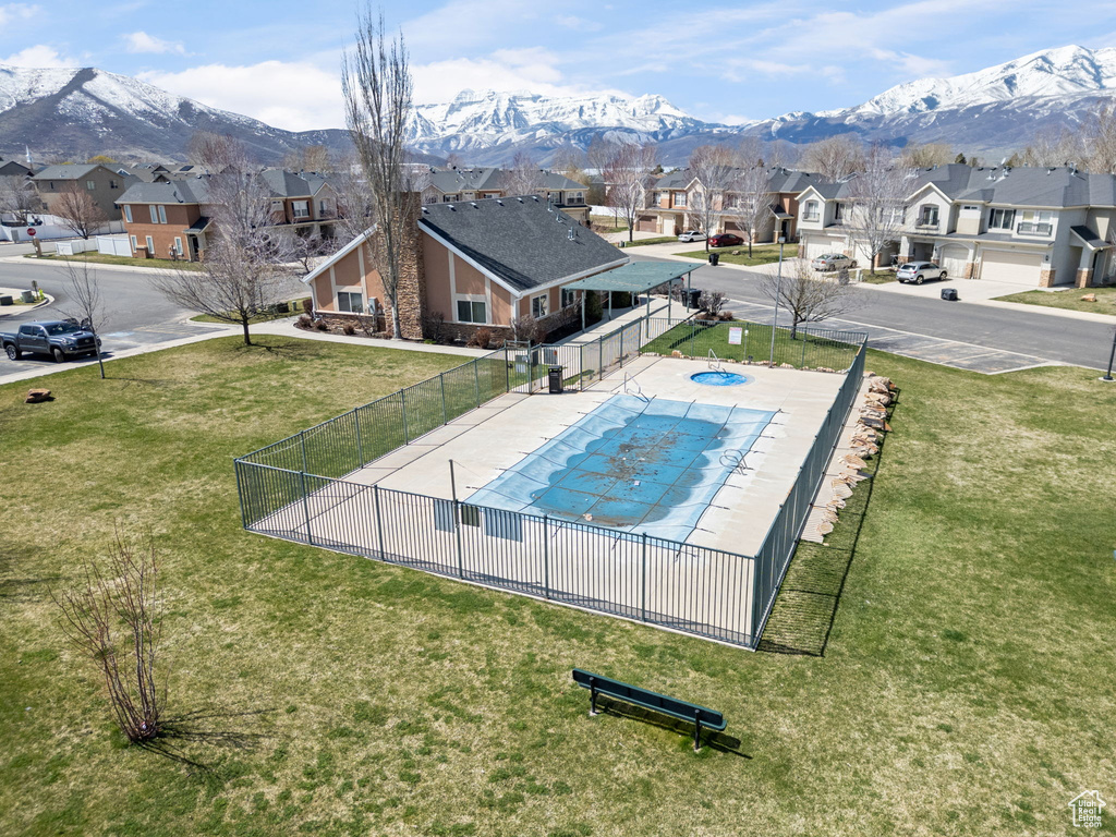 View of swimming pool featuring a mountain view and a lawn
