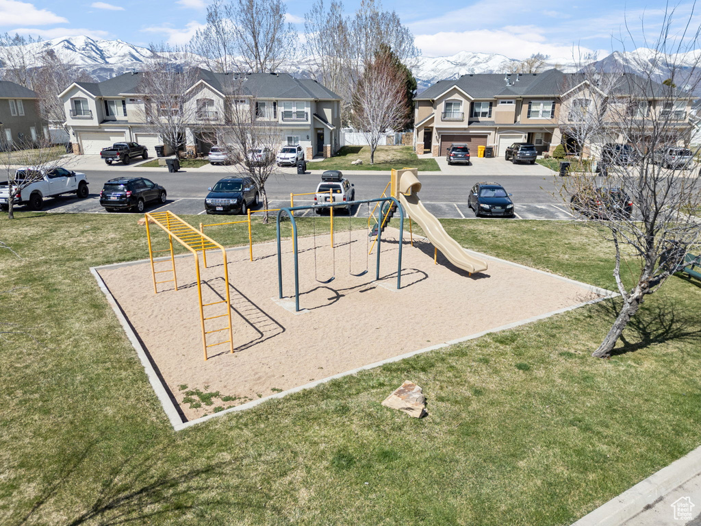 View of play area with a lawn and a mountain view
