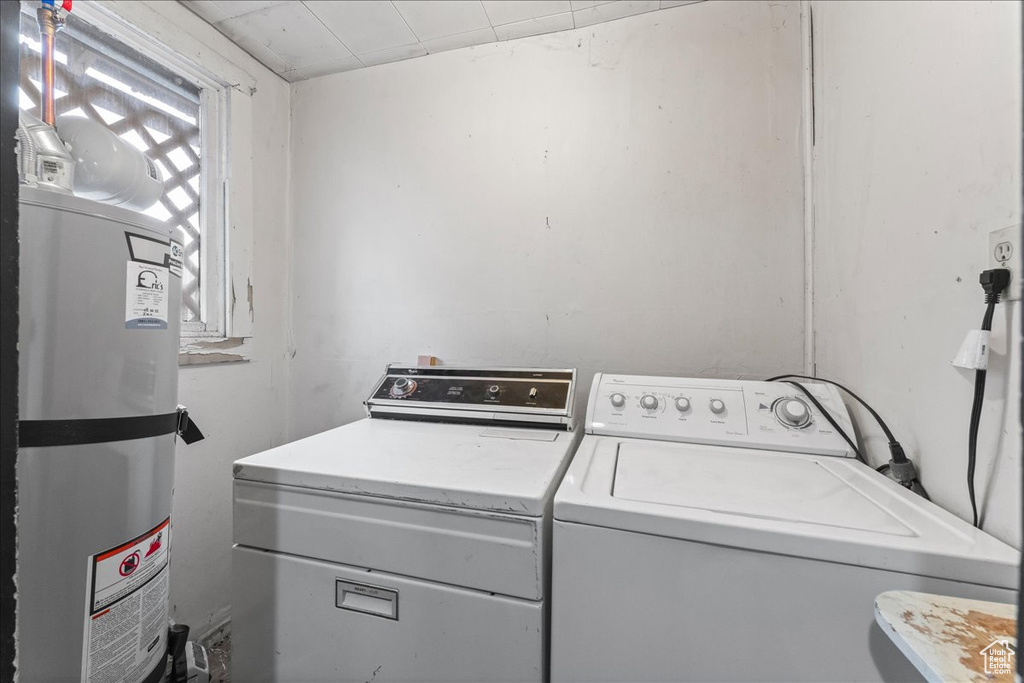 Laundry room with water heater and separate washer and dryer