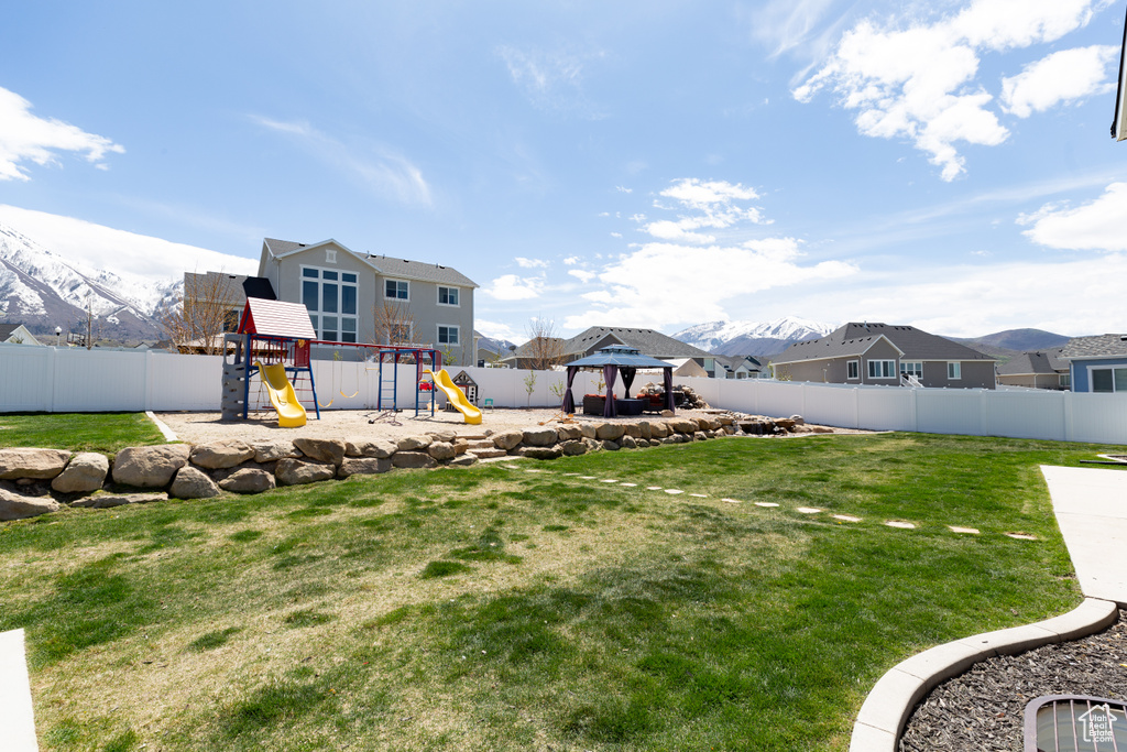 View of yard featuring a playground, a gazebo, and a mountain view