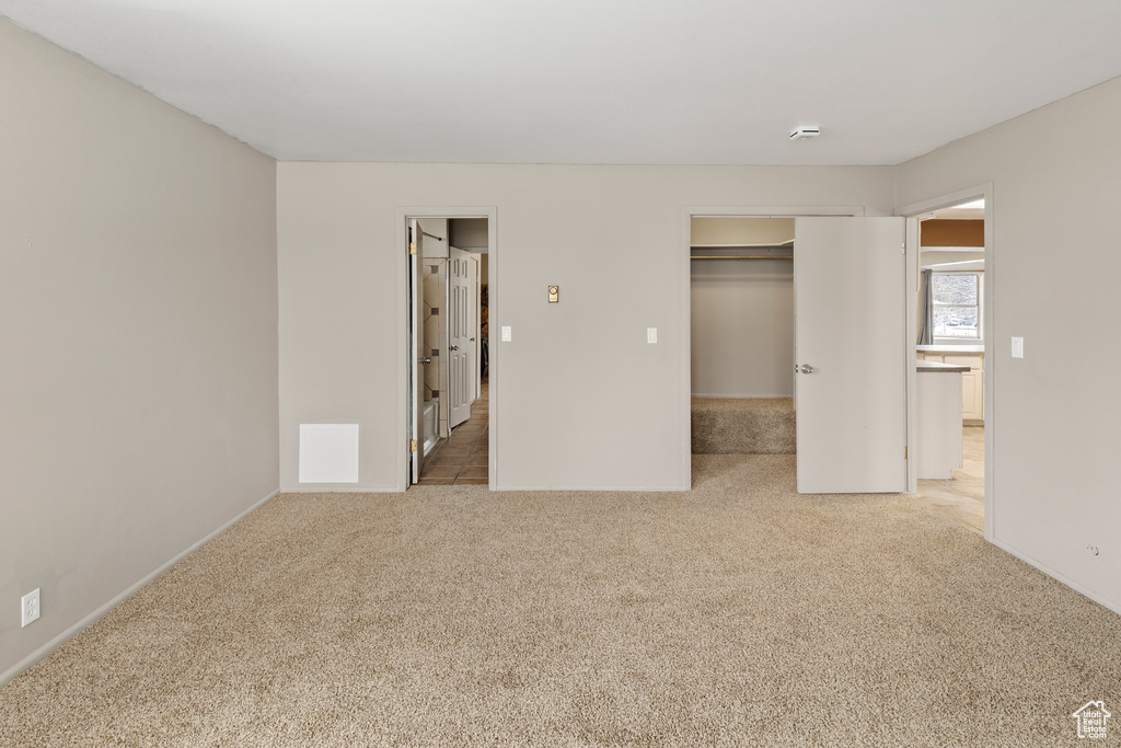 Unfurnished bedroom with a closet and light tile floors