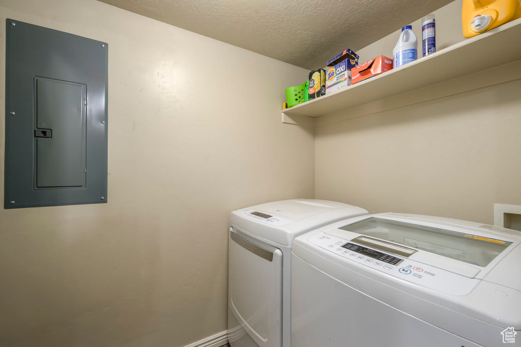 Laundry area featuring a textured ceiling and washer and dryer