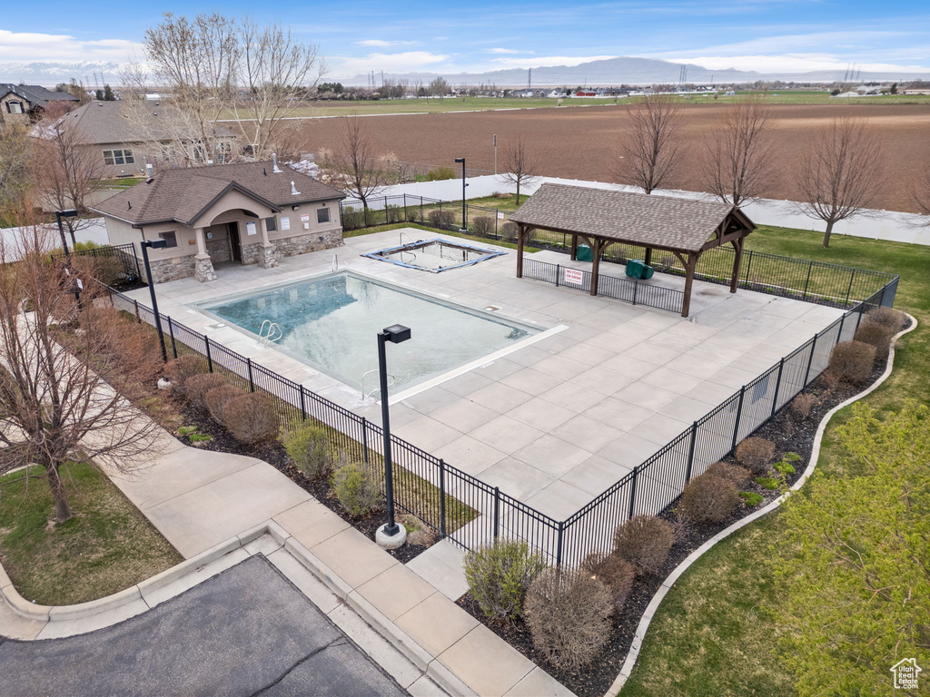 View of pool featuring a gazebo, a mountain view, a patio area, and a yard