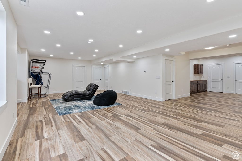Workout area with light hardwood / wood-style flooring