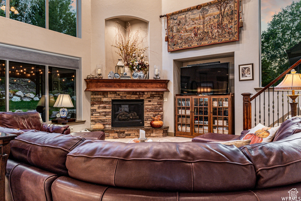 Living room with a high ceiling and a stone fireplace