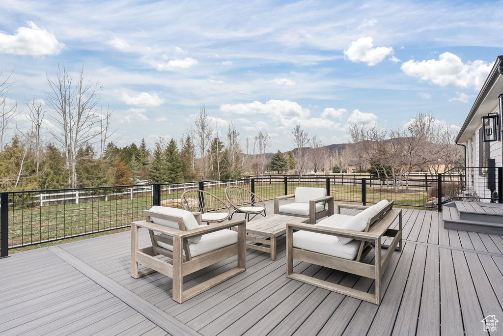 Wooden terrace featuring an outdoor hangout area
