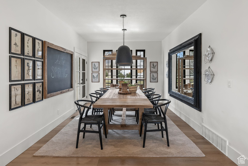 Dining space with dark wood-type flooring