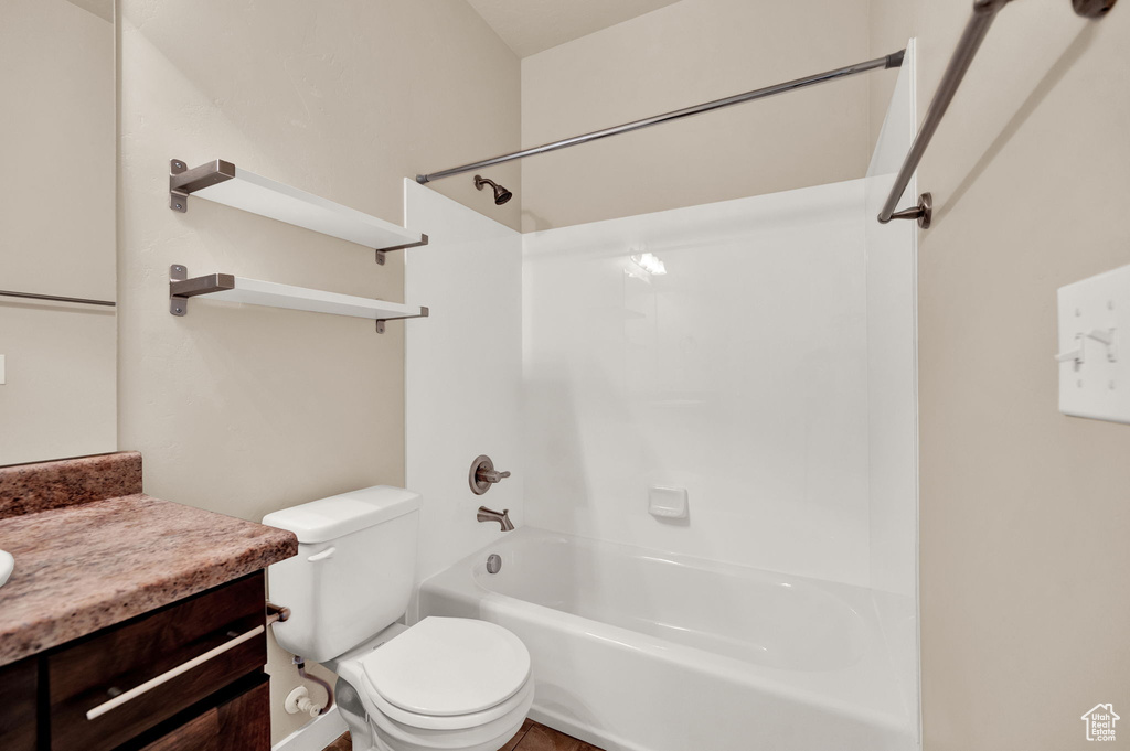 Full bathroom with bathing tub / shower combination, toilet, and vanity