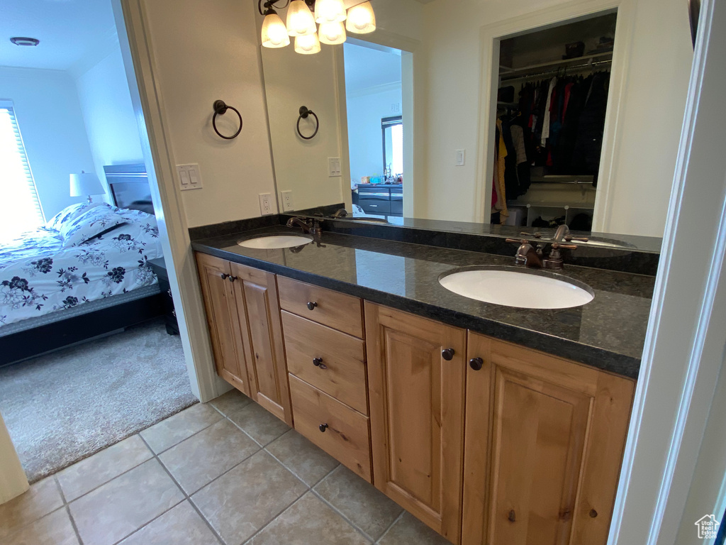 Bathroom featuring double sink vanity and tile floors
