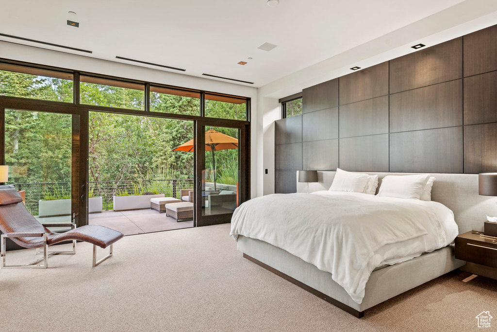 Bedroom with light colored carpet and access to exterior