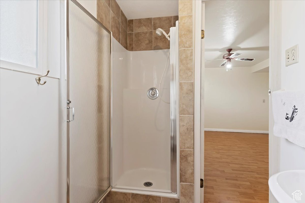 Bathroom featuring hardwood / wood-style floors, separate shower and tub, and ceiling fan