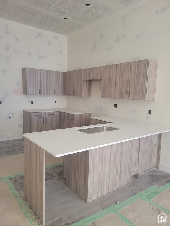 Kitchen featuring light brown cabinetry