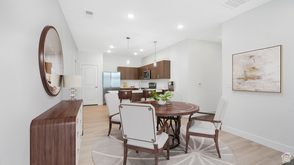 Dining area with light hardwood / wood-style floors