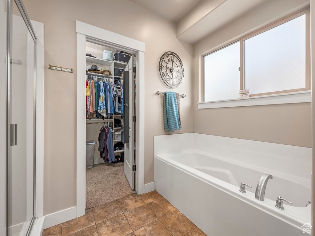 Bathroom with separate shower and tub and tile floors