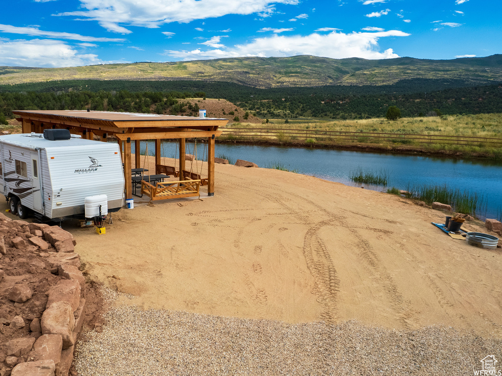 Drone / aerial view featuring a water and mountain view