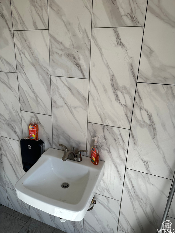 Bathroom with sink and tile walls