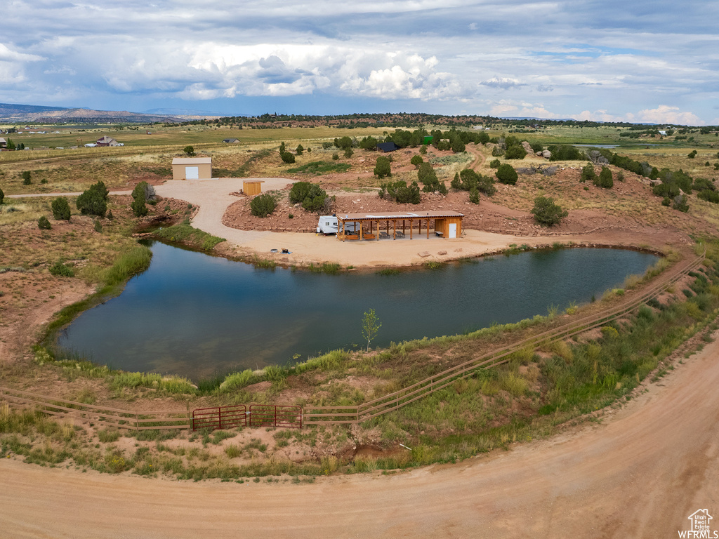 Birds eye view of property with a water view and a rural view