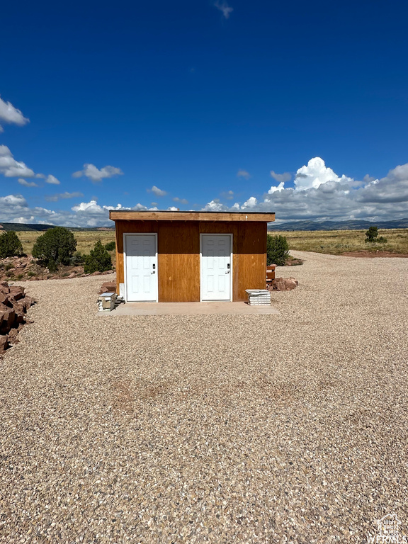 View of shed / structure with a rural view