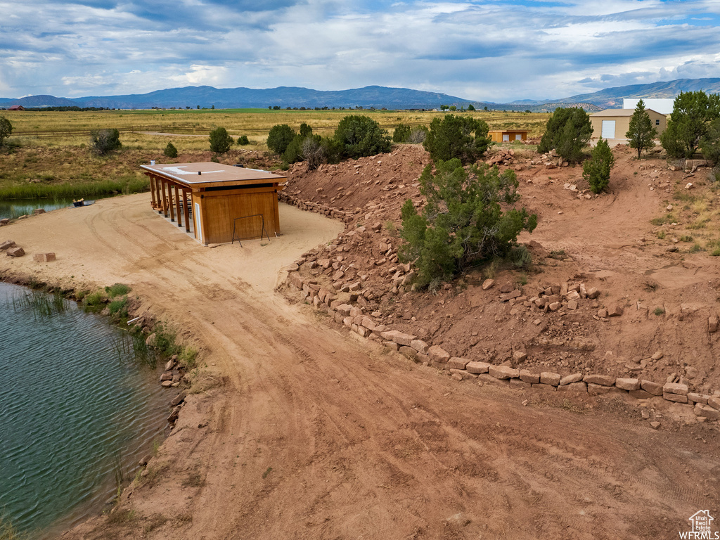 Drone / aerial view featuring a water and mountain view