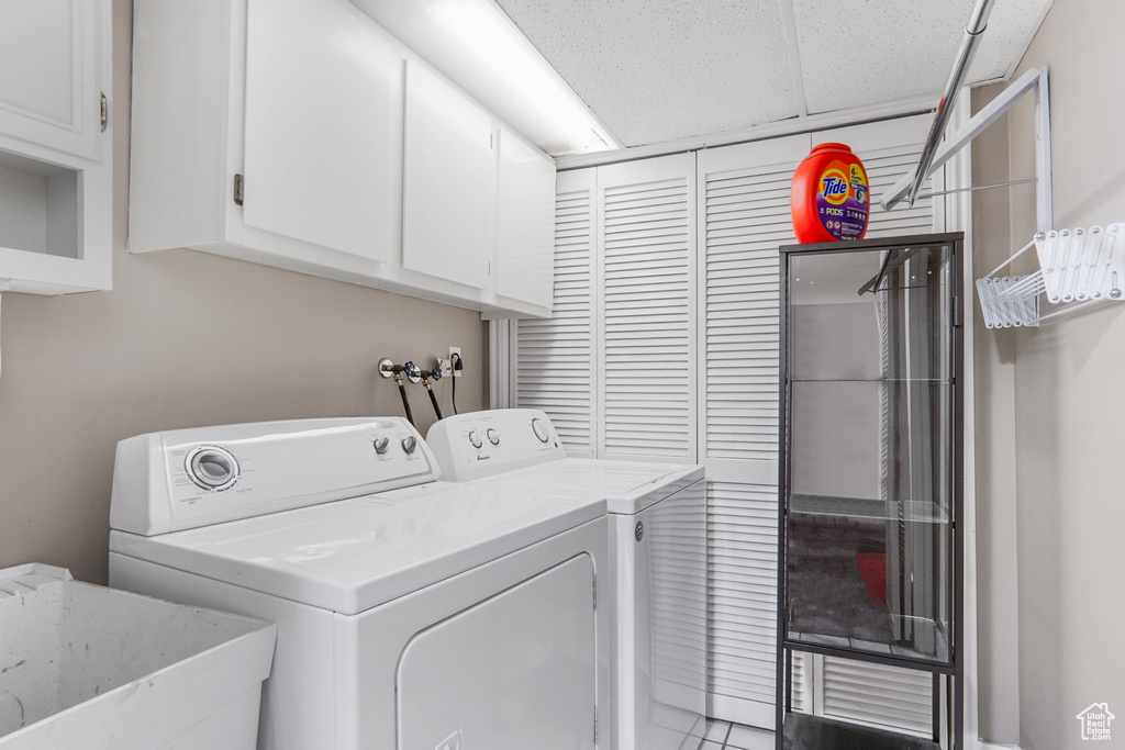 Washroom with independent washer and dryer, sink, cabinets, and hookup for a washing machine