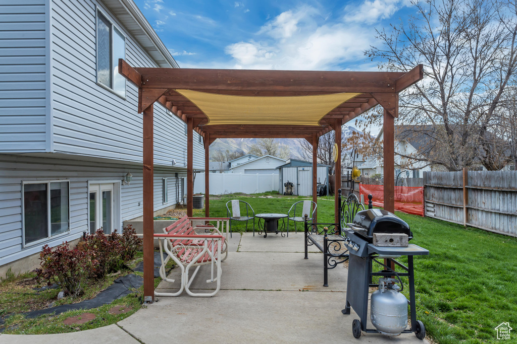View of patio / terrace featuring a storage unit and a pergola