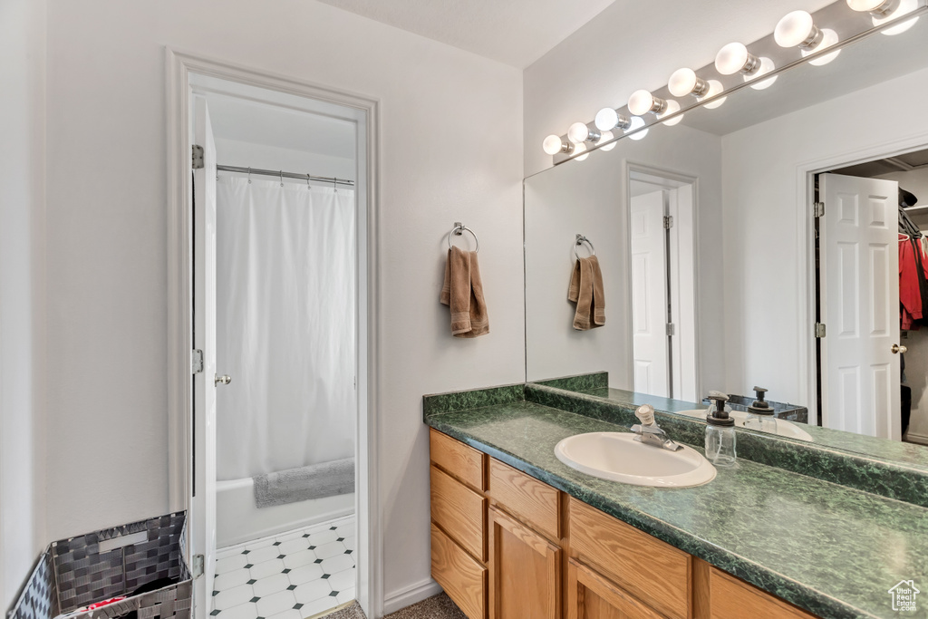 Bathroom featuring large vanity and tile flooring