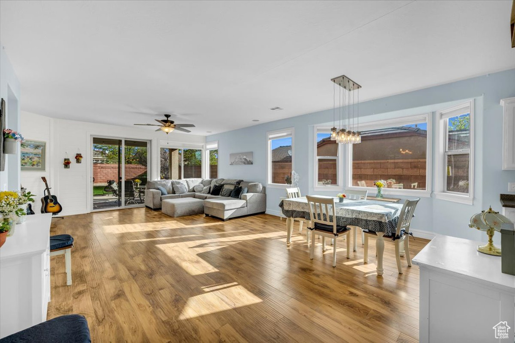 Living room featuring light hardwood / wood-style floors and ceiling fan with notable chandelier