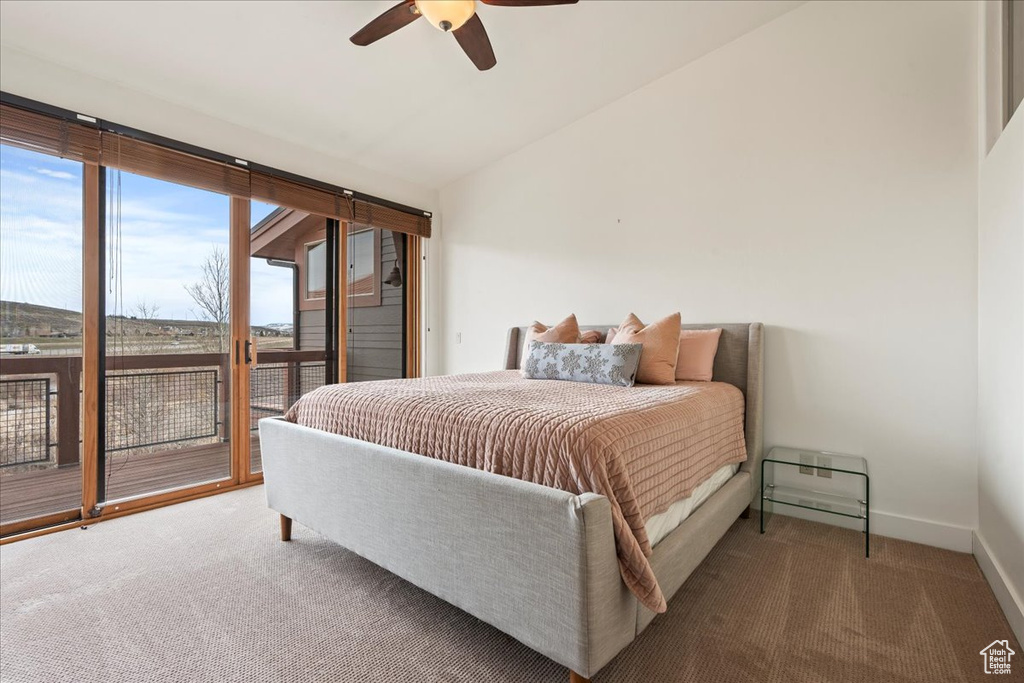 Bedroom with lofted ceiling, ceiling fan, carpet flooring, and access to outside