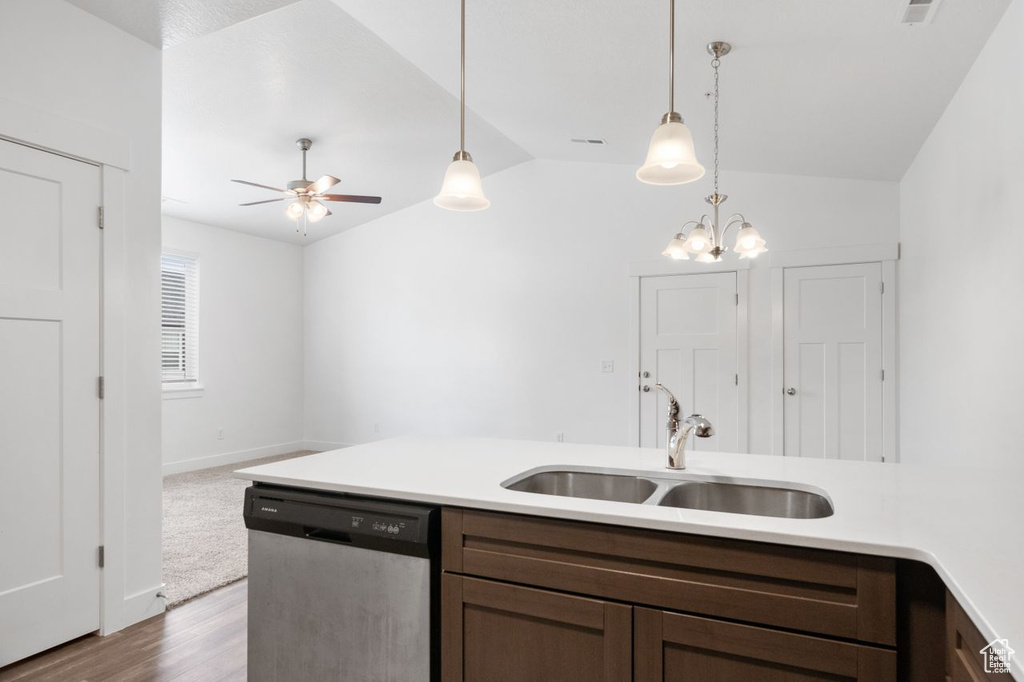 Kitchen with ceiling fan with notable chandelier, light hardwood / wood-style floors, sink, stainless steel dishwasher, and pendant lighting